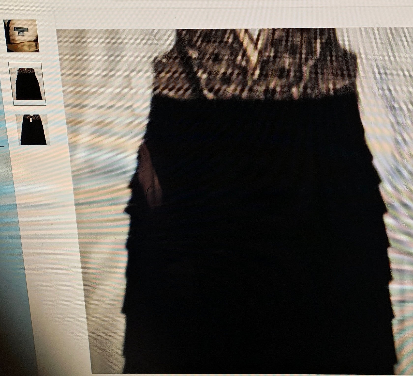 Black dress with patterned top on a textured surface
