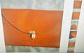 Orange clutch bag with gold tone metal shoulder strap buckle closure