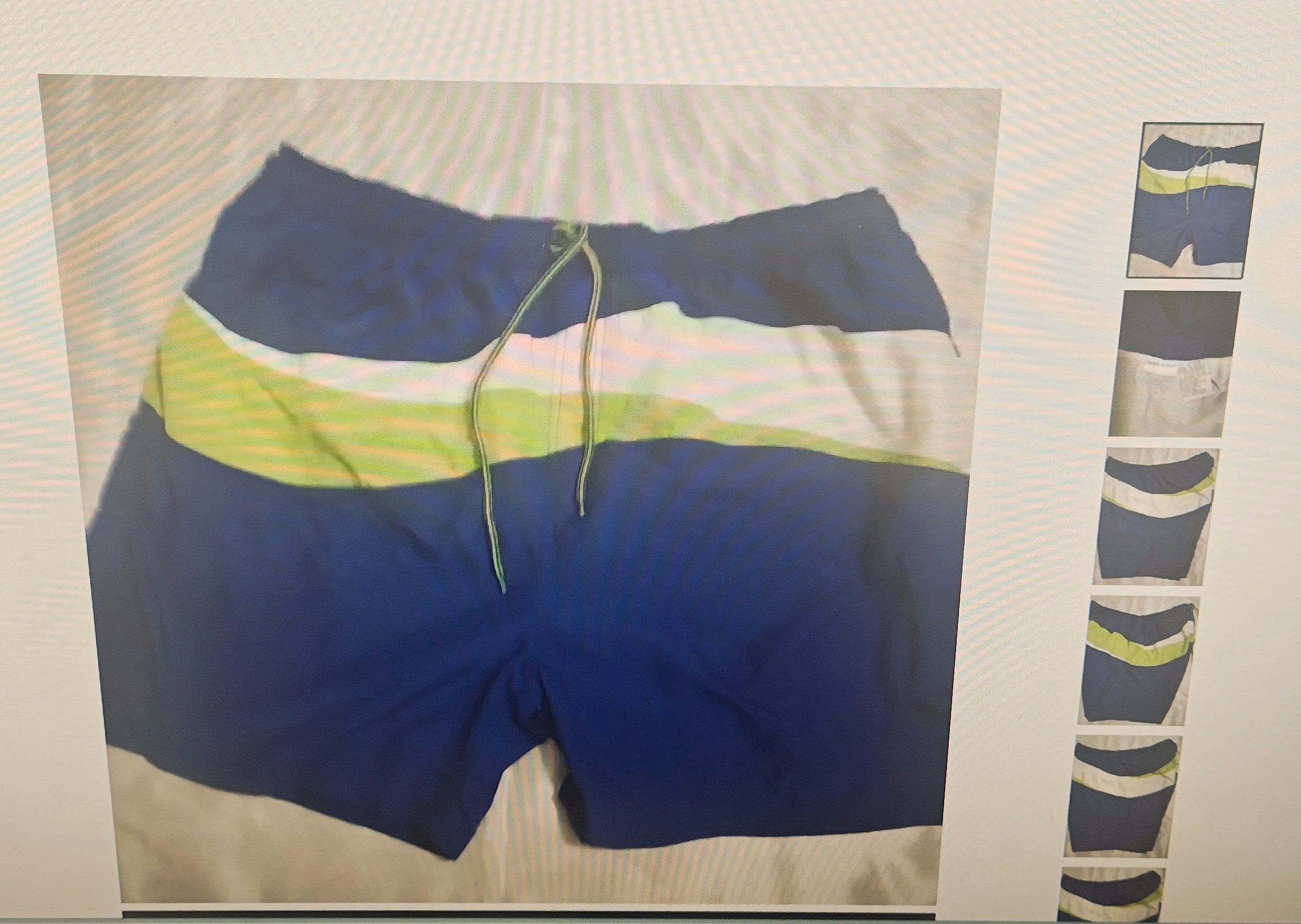 Blue and navy swim trunks with a lime green and white stripe pattern, featuring a green drawstring, shown on a light-colored background with a vertical strip of smaller thumbnail images on the right.