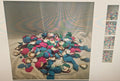 A pile of colorful seashell-shaped accessories in blue, pink, purple, and white, arranged on a light fabric surface with a small vertical strip of four smaller thumbnail images on the right.