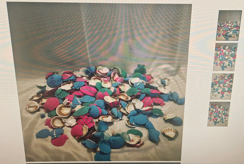 A pile of colorful seashell-shaped accessories in blue, pink, purple, and white, arranged on a light fabric surface with a small vertical strip of four smaller thumbnail images on the right.